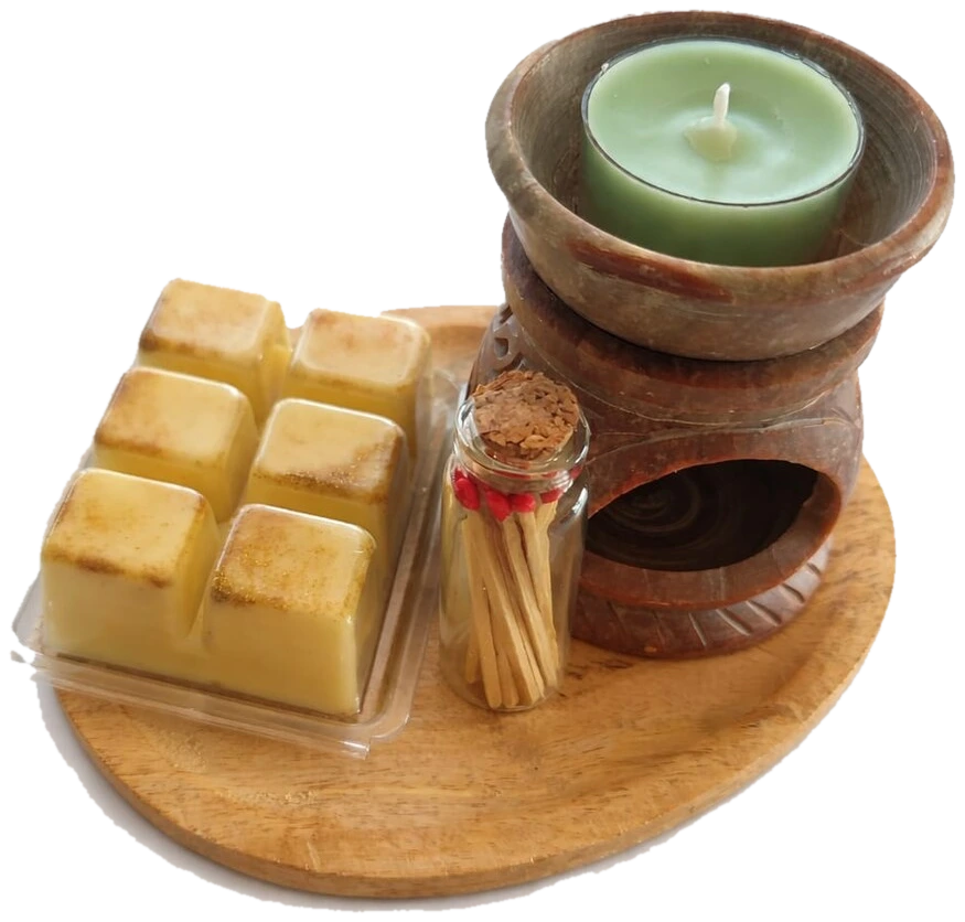 Quemador de piedra con wax melts y cerillas sobre una tabla de madera